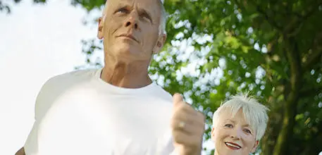Elderly man and woman jogging